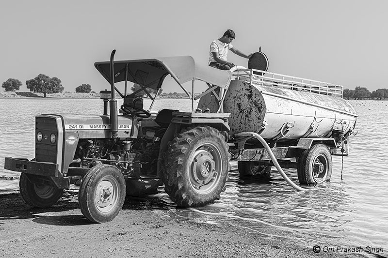 Drinking water obtained in bulk from Viprasar for storage at home or supply to other needy families in Netsi village, Thar Desert, Jaisalmer district, Rajasthan, India